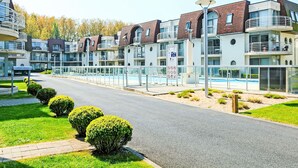 Un hôtel moderne doté de plusieurs étages, de balcons et d’une piscine.