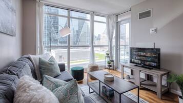 Signature Apartment | Living area | 48-inch Smart TV with satellite channels