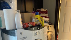 Un lave-linge à chargement frontal doté d’un panneau de commande et d’un sèche-linge placé au-dessus.
