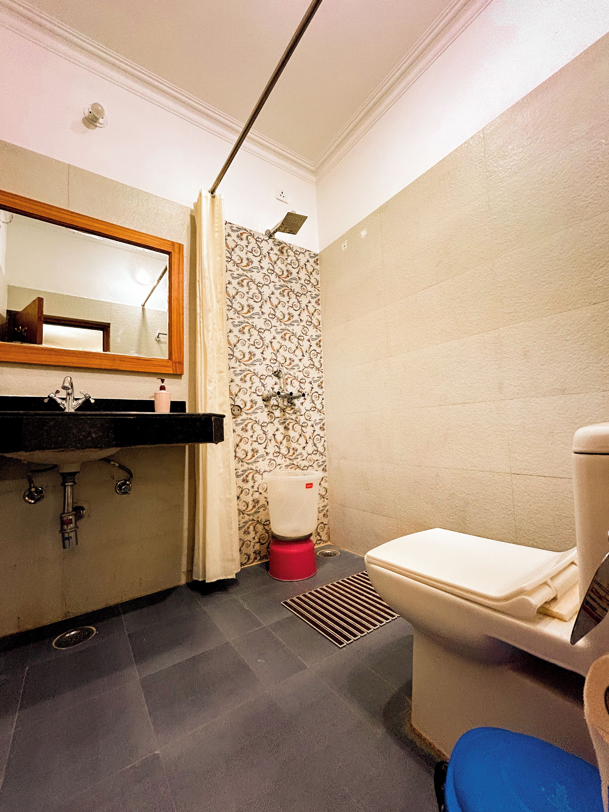 Un bagno piccolo ma funzionale, con lavandino, specchio, WC e doccia.