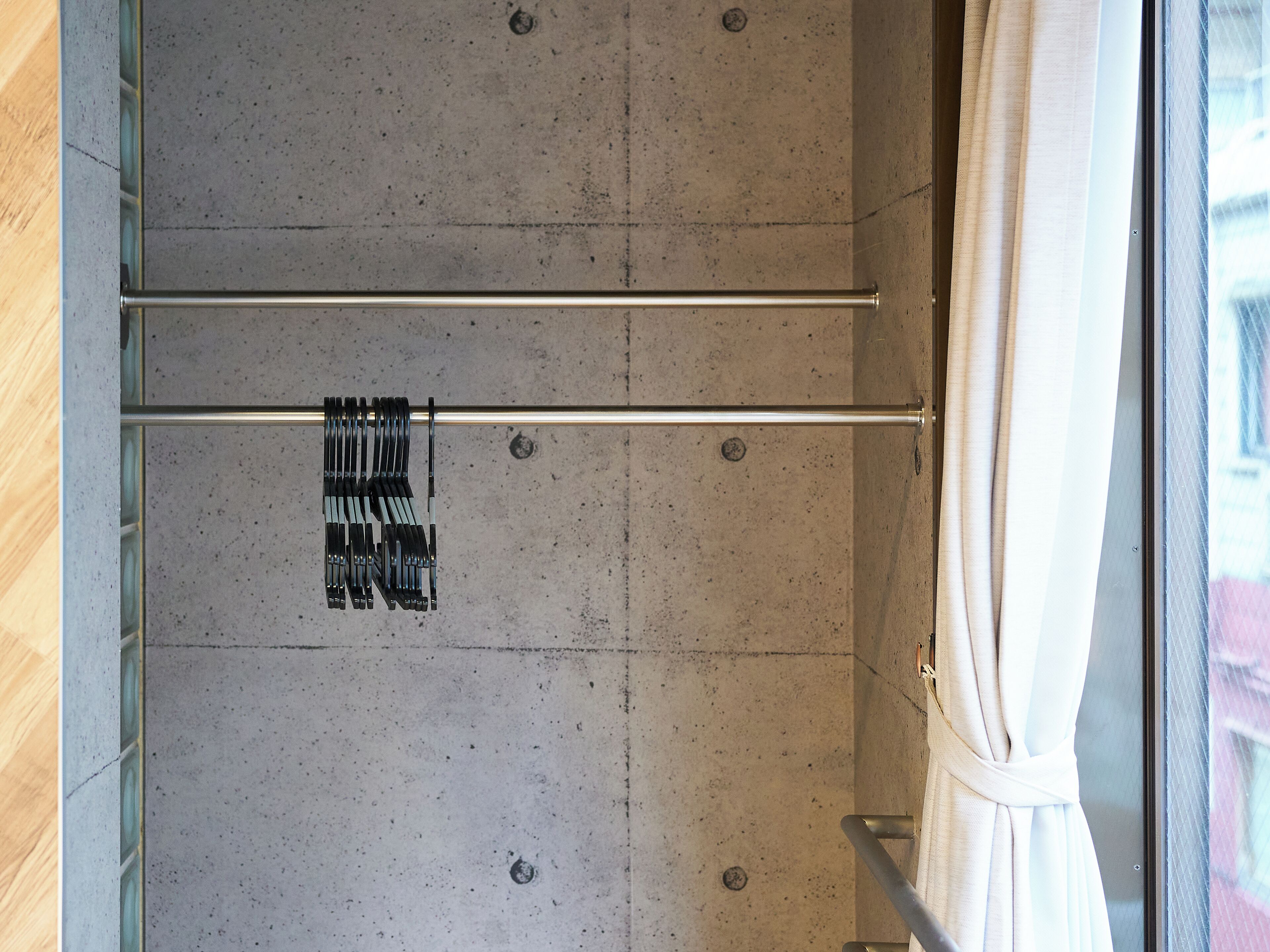 A bathroom with a towel rack and a shower curtain.