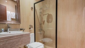 A modern bathroom with a glass-enclosed shower, a marble sink, and a toilet. - Jazalah al falah serviced apartments  (Riyadh)