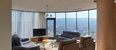 Deluxe Apartment, City View | Living area | Flat-screen TV