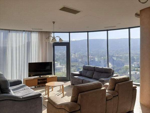 Deluxe Apartment, City View | Living area | Flat-screen TV