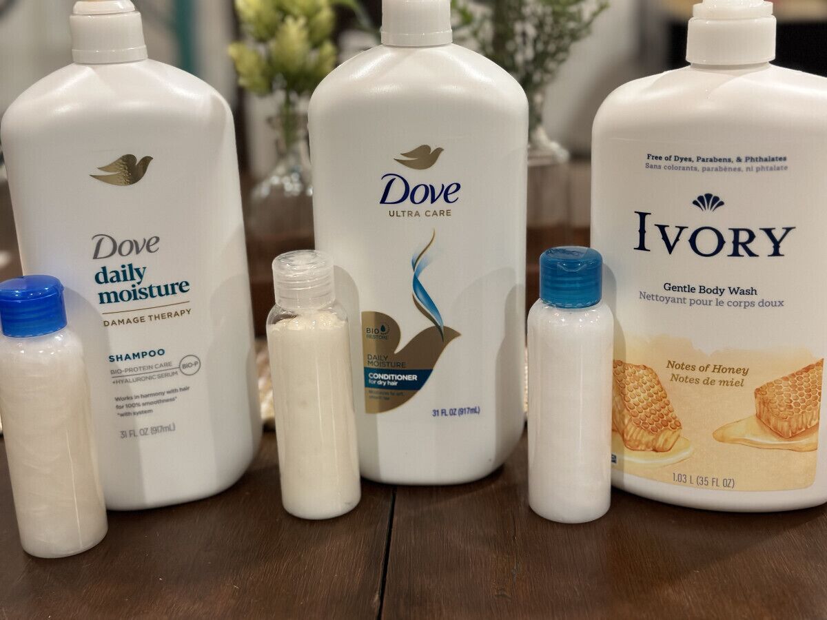 A collection of Dove and Ivory personal care products on a wooden surface.