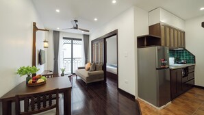 A modern apartment with a dining area, a living room, and a kitchen.