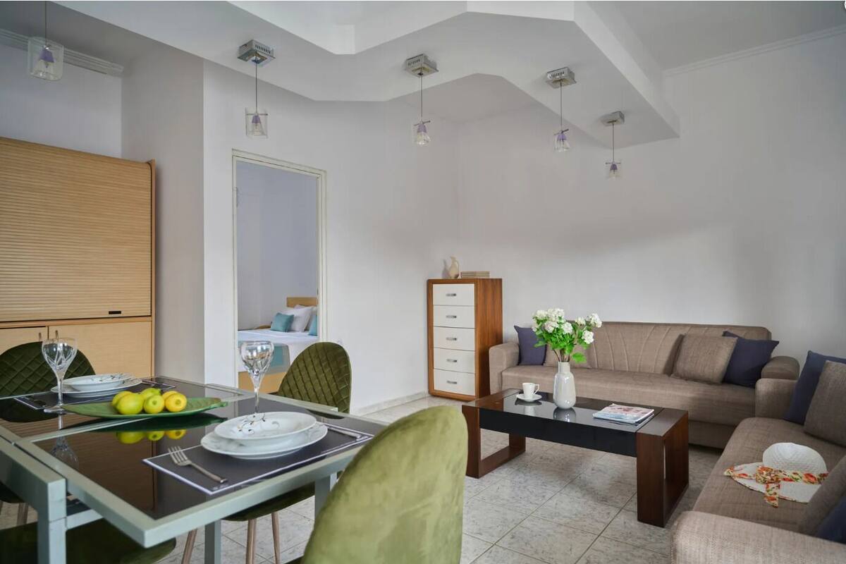 A modern living room with a dining area, a sofa, and a coffee table.