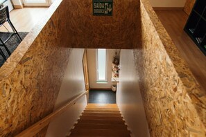 Staircase with a unique design, featuring a central staircase and wooden walls.