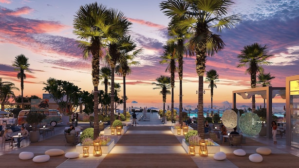 A sunset view with palm trees, outdoor seating, and a pool area. - Rove Al Marjan Island (Ras Al Khaimah)