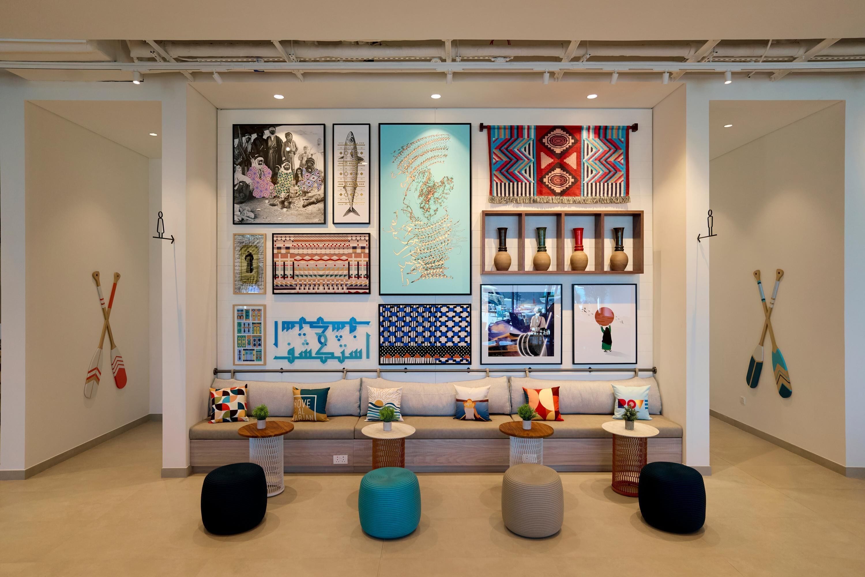 A modern interior with a sofa set, decorative pillows, and wall art.