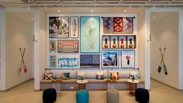 A modern interior with a sofa set, decorative pillows, and wall art.