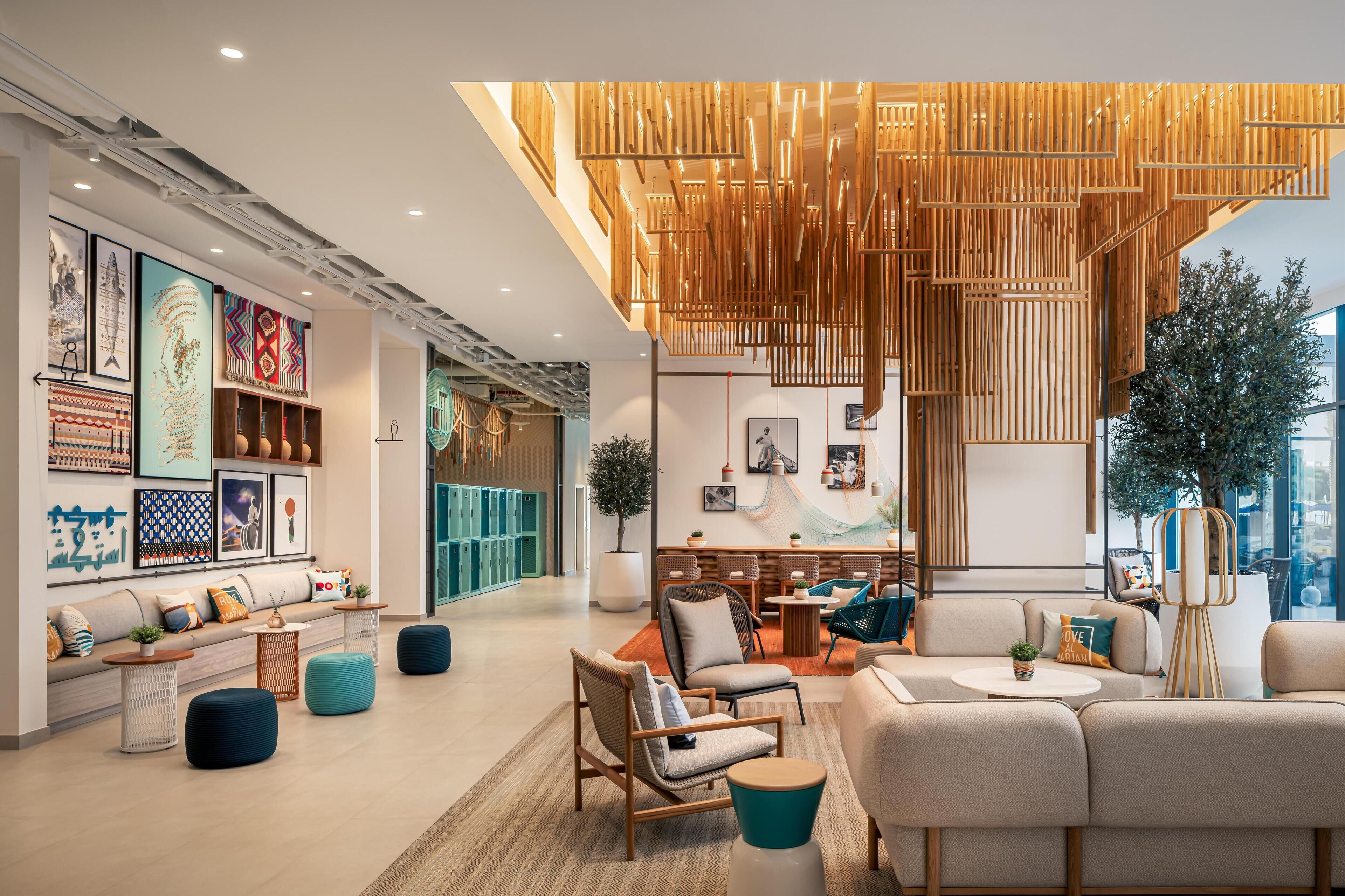 A modern interior with a sofa, chairs, and a dining area.