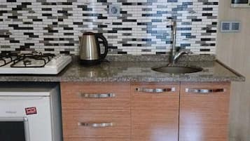 Mini-fridge, stovetop, cookware/dishes/utensils