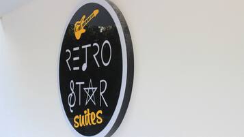 A circular sign with the text "RETRO STAR SUITES" and a guitar icon.