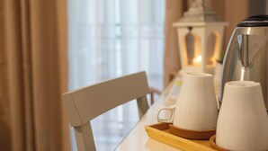 A table with a white coffee maker, two white cups, and a tray. - Palazzo Carella (Palermo)