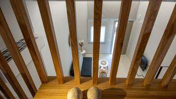 A wooden staircase with two spherical objects on the landing.