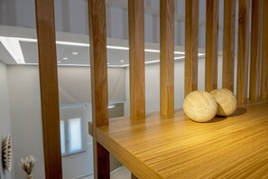A wooden table with two spherical objects, possibly decorative items, and a wooden slat structure behind it.