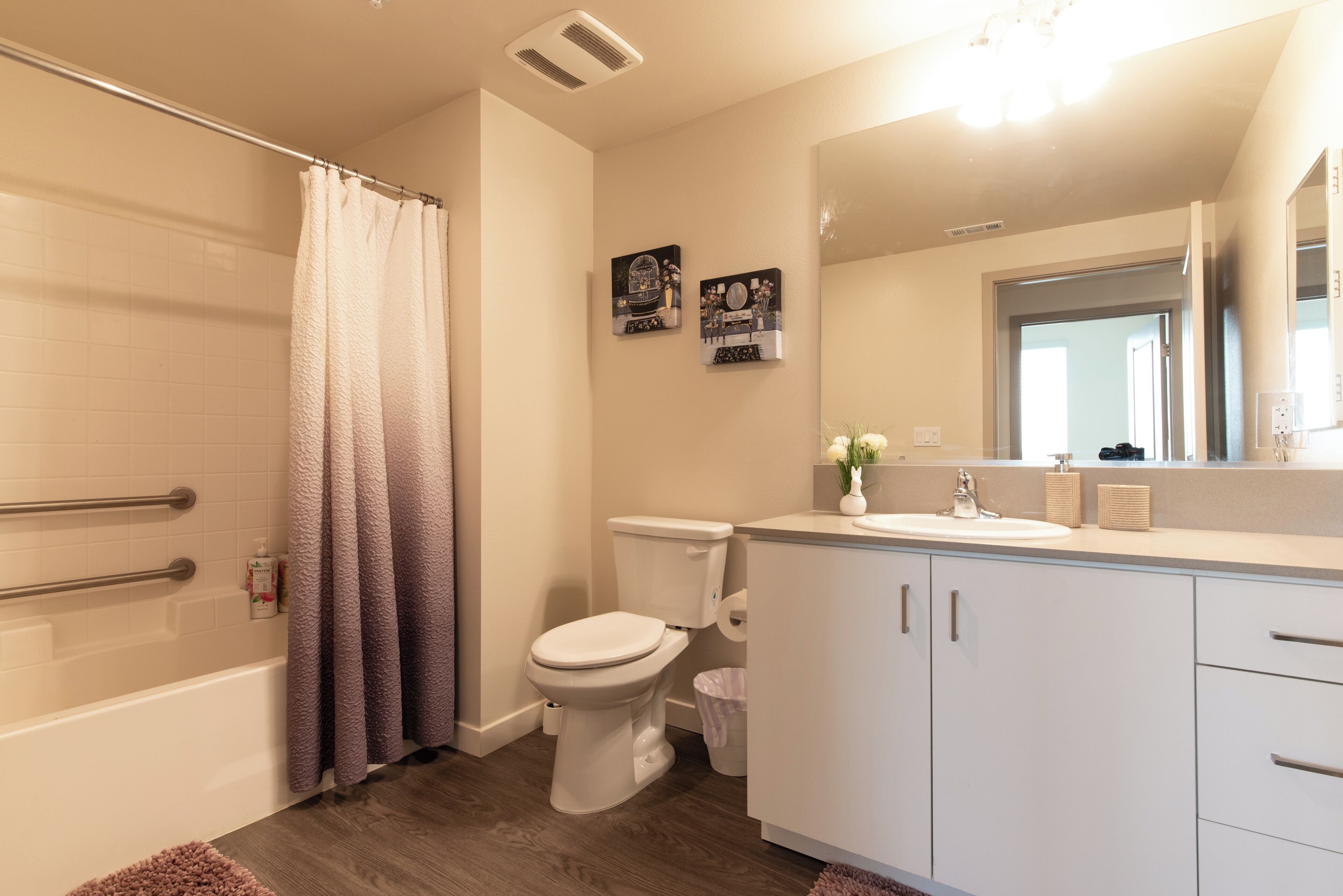 A modern bathroom with a bathtub, toilet, and sink.