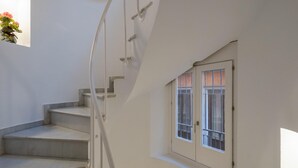 A staircase with a handrail leading to a landing.