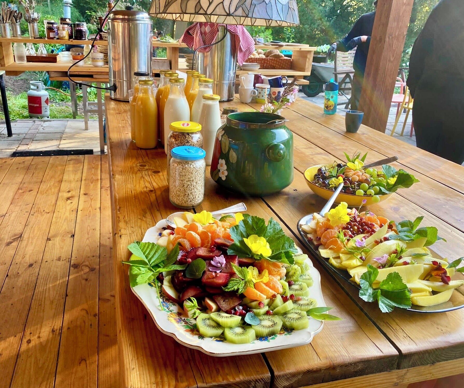 A wooden table with various food items and kitchenware.