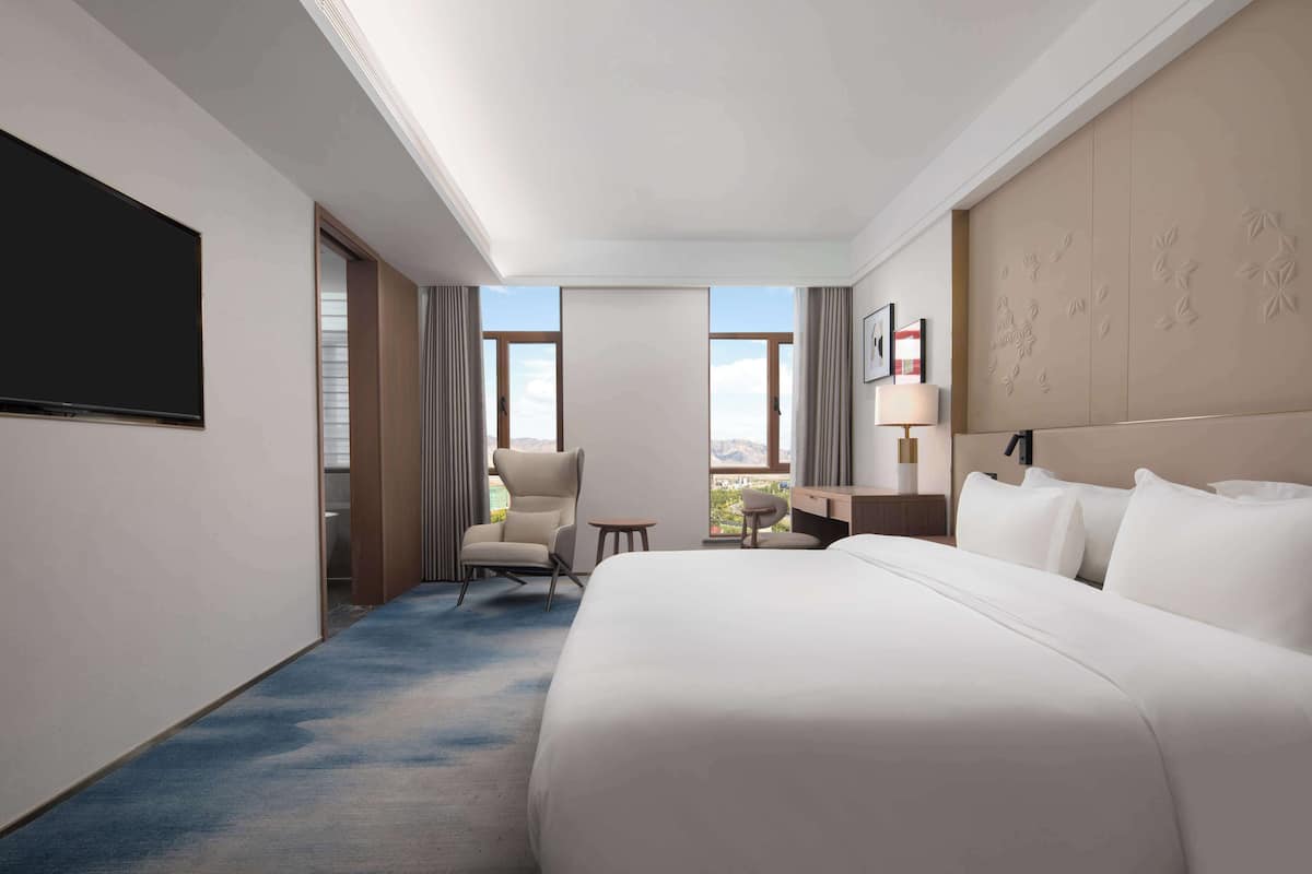 Deluxe Suite, 1 King Bed | In-room safe, desk, laptop workspace, blackout drapes