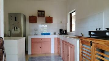 Fridge, electric kettle, cookware/dishes/utensils, dining tables