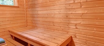 .finnish chalet with sauna entrance to haut jura nature park, open countryside