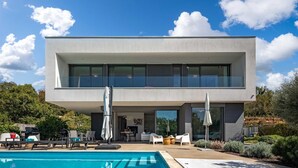 A modern two-story house with a swimming pool, outdoor seating, and a garden. - Villa Luxor With Heated Pool (Malinska-Dubasnica)