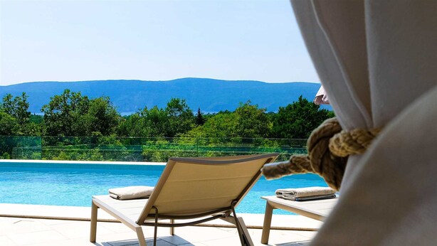 A poolside area with two lounge chairs and a view of a mountain range. - Villa Afrodita With Private Pool (Krk)