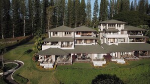 A multi-story resort with a central courtyard, surrounded by dense forest.