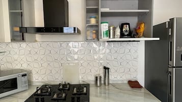 Fridge, microwave, stovetop, cookware/dishes/utensils