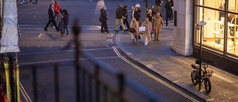 A busy urban street scene with pedestrians and vehicles.