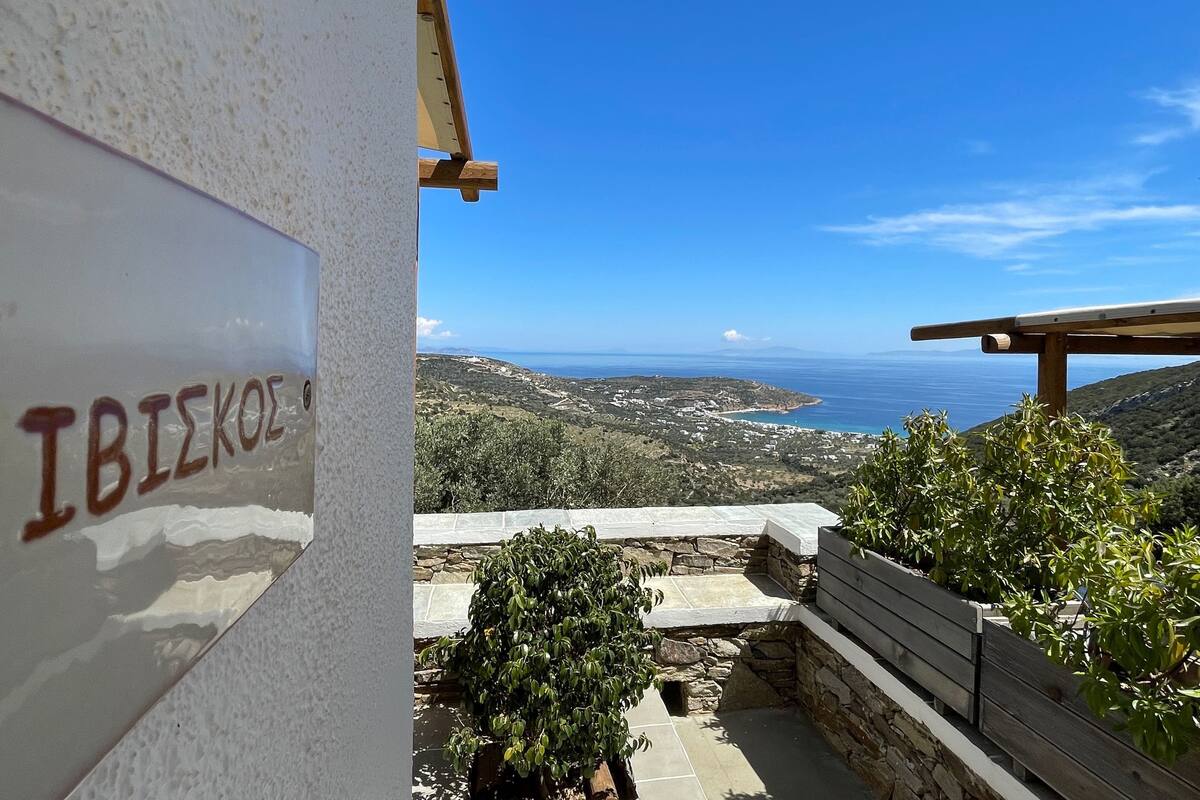 A view of a coastal landscape with a sign reading "IBIKE".