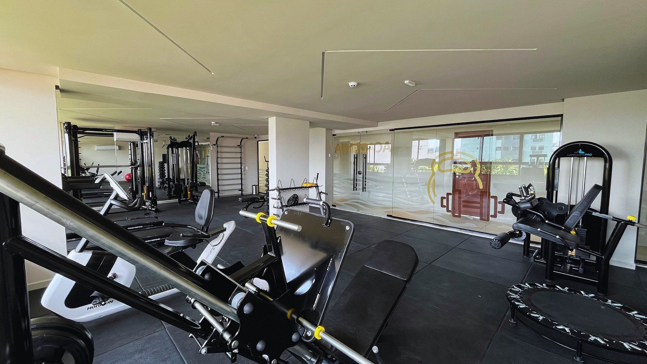 A gym with various exercise equipment, including treadmills and weight machines.