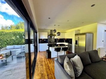 Open living space connecting kitchen living room and outside garden