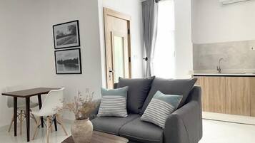 Junior Apartment, Balcony, City View | Living area | Flat-screen TV