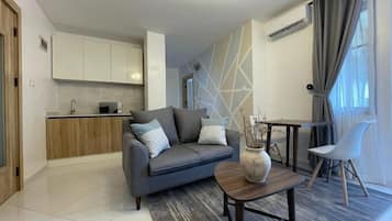Junior Apartment, Balcony, City View | Living area | Flat-screen TV