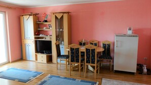 A compact living space with a dining area, a TV, and a refrigerator. - Cozy Retreats in Crikvenica Quiet Neighborhood (Crikvenica)
