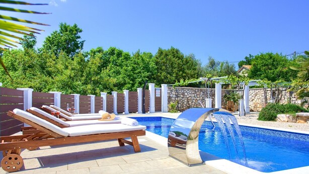 A pool with lounge chairs and a water feature. - Tranquil Getaway Polje Villa With Pool (Dobrinj)