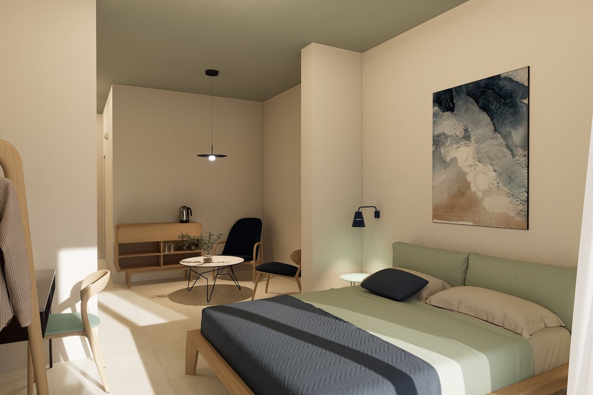 A modern bedroom with a bed, bedside table, and a painting on the wall.