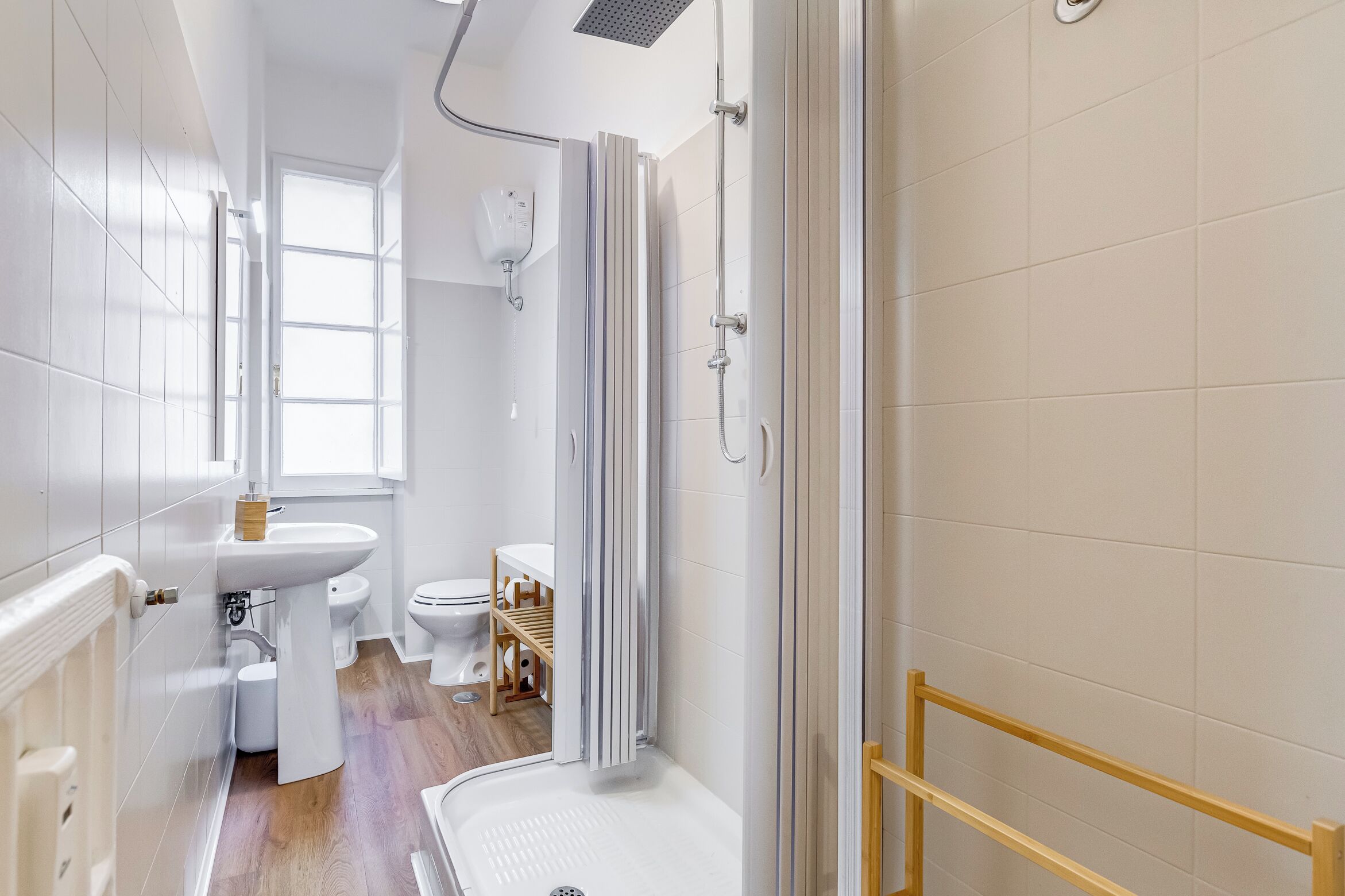 A modern bathroom with a shower, toilet, and sink.