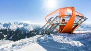 A snow-covered mountain landscape with a large orange structure in the foreground. - Apartment Bad Gastein Near Ski Lift (Bad Gastein)