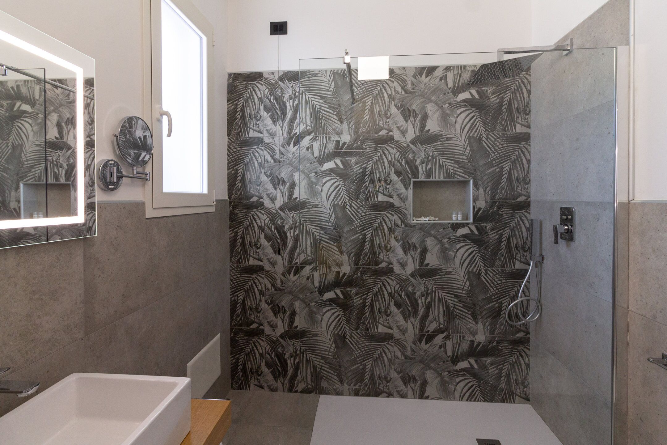 A modern bathroom with a shower, a bathtub, and a toilet.