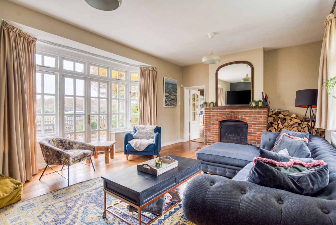 A living room with a fireplace, a sofa, a chair, and a coffee table.