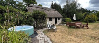 Thatched cottage with hot tub, games room, and garden – ideal for romantic breaks or family escapes