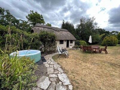 Thatched cottage with hot tub, games room, and garden – ideal for romantic breaks or family escapes