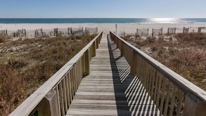 A wooden boardwalk leading to a beach with a clear view of the ocean. - The Palms West 813 (Orange Beach)