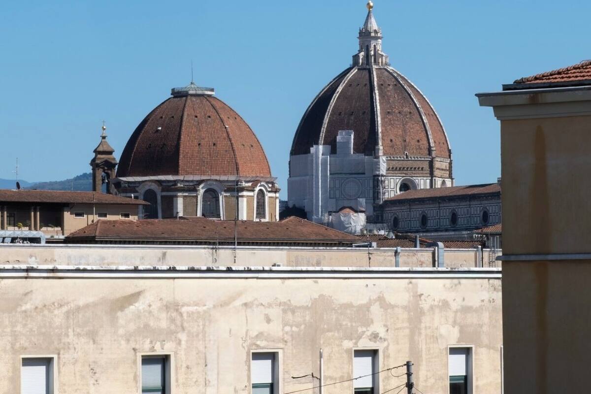 Two prominent domed buildings with a clear blue sky in the background.