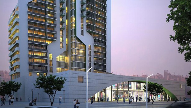 Un moderno edificio de gran altura con varios pisos, ventanas amplias y un diseño arquitectónico único.