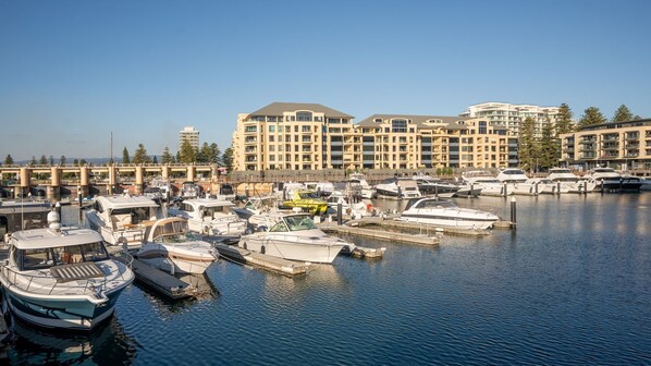 Marina with modern residential buildings and a variety of boats docked.
